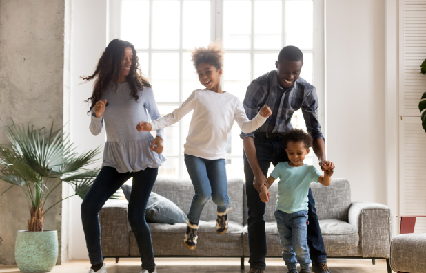 A family jumping for joy because they received a personal loan from one of their family members because of their poor credit score